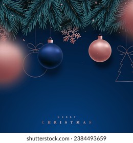 Xmas background with fir branches and rose gold balls, snowflakes on dark blue background. Festive design template for winter holidays. 