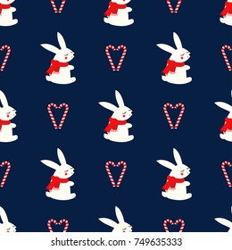 Xmas bunny with candy canes heart seamless pattern on dark blue background. Happy New Year and Merry Xmas background. Vector design for textile, wrapping paper, fabric. Baby animal illustration.