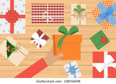 Xmas greeting card with fir branches and Christmas bells. Vector eps10 illustration. Hand holding gift boxes. Female hands holding gift box