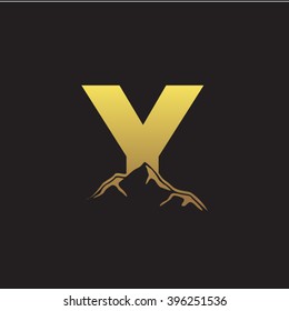 Y alphabet mountain negative space letter logo gold black background