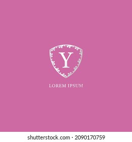 Y Letter Initial logo design template. Luxury silver decorative floral shield illustration. Suitable for Insurance, fashion and beauty product. Isolated on pink color background.