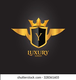 Y Letter Luxury Golden Crest logo with wings and crown isolated in black background 