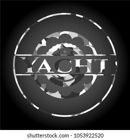 Yacht written on a grey camouflage texture