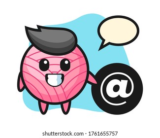Yarn ball cartoon standing beside the At symbol