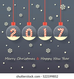 year 2017 sign in red and white Christmas sweet style in snow globe hanging on dark background with snow and snowflakes.