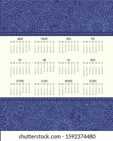 Year 2020 vector monthly calendar over lacy doodle ornate hand drawn blue background. Week starting from Sunday.