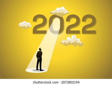 Year 2022 with bright spotlight from number zero light up on hopeful businessman