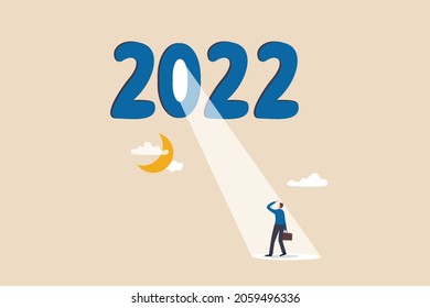 Year 2022 business opportunity, bright future on economic recovery, hope or motivation to overcome difficulty concept, year 2022 with bright spotlight from number zero light up on hopeful businessman.