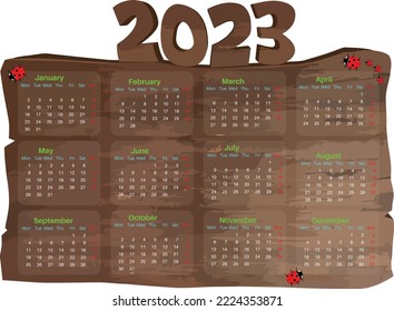 Year 2023 calendar displaying on woods with ladybirds crawling on it.
