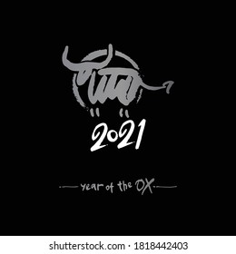 Year of the Ox on the Chinese calendar. Stylish new year card with metal bull on black background. Calligraphy symbol of the year 2021. Vector element for New Year's design.
