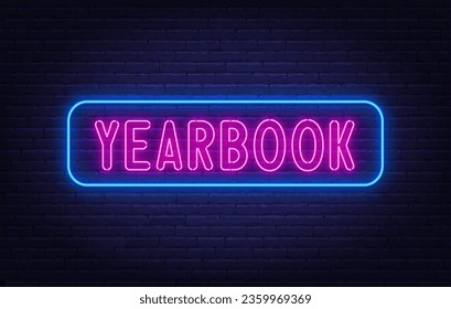 Yearbook neon sign on brick wall background.