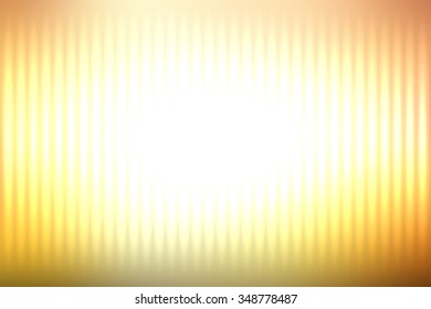 Yellow abstract blur colored background with defocused vertical rays of light.