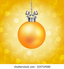 Yellow christmas ball on sparkling background.