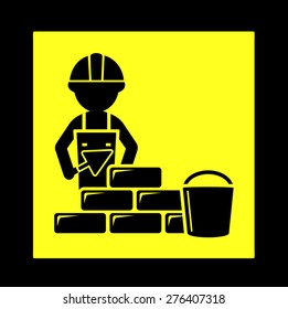 yellow construction icon with builder laying brick wall 