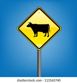 Yellow diamond hazard warning sign against blue sky - cattle warning sign, vector version