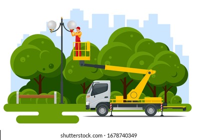 Yellow Engine Powered Scissor Lift. Worker with the help of an automobile tower change repairing a street pole.