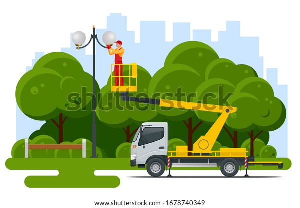 Yellow Engine\
Powered Scissor Lift. Worker with the help of an automobile tower\
change repairing a street\
pole.