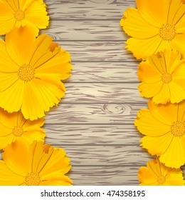 Yellow flowers on wooden background.