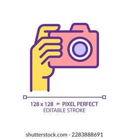 Yellow hand with camera RGB color icon. Person taking shot with analog equipment. Photographer tool. Photography technique. Isolated vector illustration. Simple filled line drawing