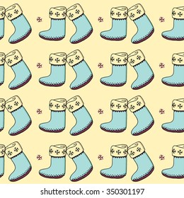 Yellow hand drawn seamless pattern with turquoise felt boots and snowflakes. Decorative vector ornamental background with christmas stocking. Can be used for textile design, bag template, packaging.