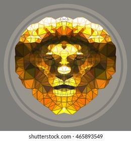 The yellow head of a lion on a grey background. Polygonal graphics. 
