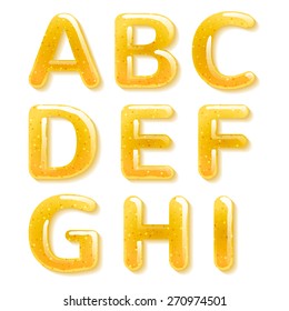 Yellow honey jelly abc alphabet. Glossy letters isolated on white background.