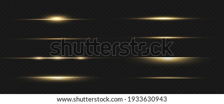 yellow horizontal lens flares pack. Laser beams, horizontal light rays. Beautiful light flares. Glowing streaks on dark background. Luminous abstract sparkling lined background.