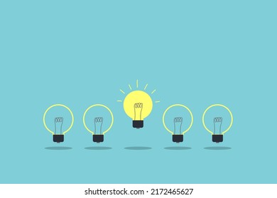 yellow light bulb standing out from the unlit incandescent bulbs. Individuality and different creative idea concepts. leadership