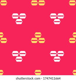 Yellow Macaron cookie icon isolated seamless pattern on red background. Macaroon sweet bakery.  Vector