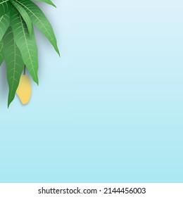Yellow Mango and leave on blue background with copy space. 