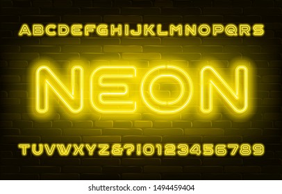 Yellow neon alphabet font. Bright light bubble letters and numbers on brick wall background. Stock vector typescript for your design.