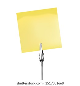 Yellow note on a metal memo holder clip. Note on wire silver clamp with place for you text over white background. Office supplies. Vector illustration