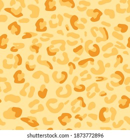 Yellow orange leopard print. Seamless pattern imitation of animal skin. Trendy texture with spots of leopard, cheetah, wild cat. Vector illustration, camouflage background.