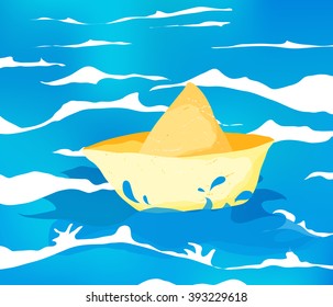 Yellow paper boat sailing in the ocean