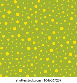 Yellow polka dots seamless pattern on green background.
