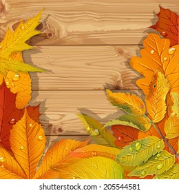 Yellow and red autumn leaves wooden background