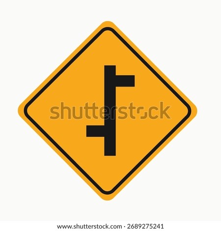 A yellow road sign warns drivers of a side road junction, advising awareness of merging traffic and potential hazards at the intersection. Isolated on white.
