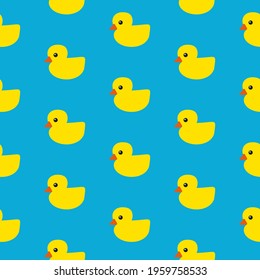 Yellow rubber ducks with orange beaks and black eyes on blue background, seamless pattern 