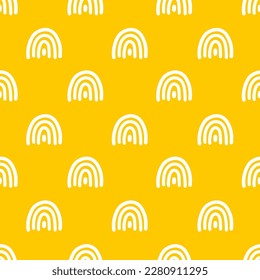 Yellow seamless pattern with white hand drawn rainbows