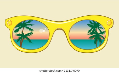 Yellow sunglasses with a reflection of sea, sky and palm trees. 