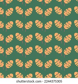 Yellow tropical leaves vector seamless pattern on a green background