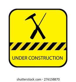 Yellow under construction road sign, with screwdriver, hammer and text under construction