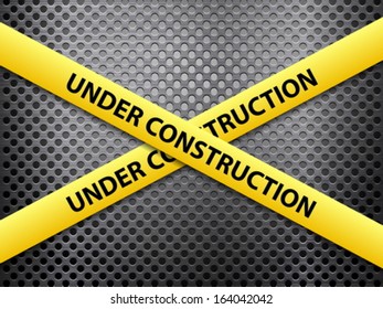 Yellow under construction tape on a metal background.
