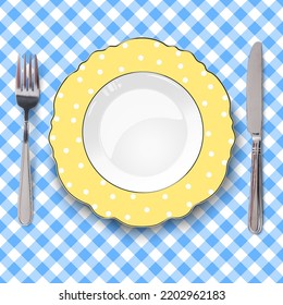 Yellow vector plate with figured edges and polka dot pattern placed on blue check classic seamless tablecloth. Close up view from above.