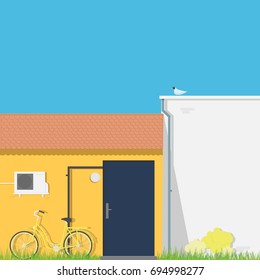 Yellow wall with dark back door and air conditioning.Women's bicycle on the grass in backyard