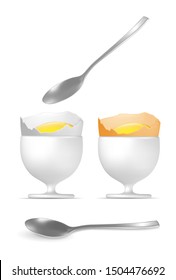 Yellow and white boiled eggs with spoon and egg cups