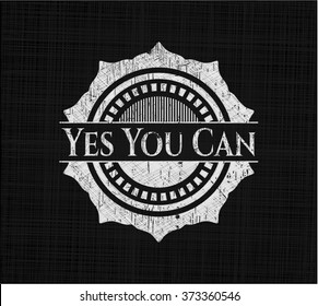 Yes You Can chalk emblem written on a blackboard