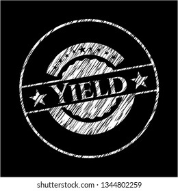 Yield chalk emblem written on a blackboard