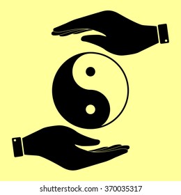 Ying yang symbol of harmony and balance. Save or protect symbol by hands.