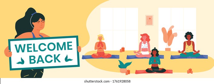 Yoga instructor holds welcome back banner, informing her clients about the resumption of yoga classes after covid-19 lockdown. Women doing padmasana or lotus pose. Physical and mental health.